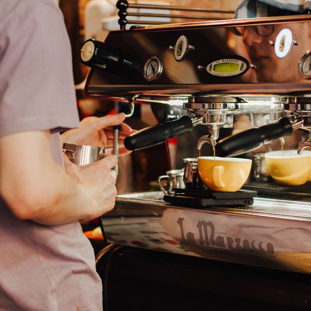 Cafe- a person making a coffee