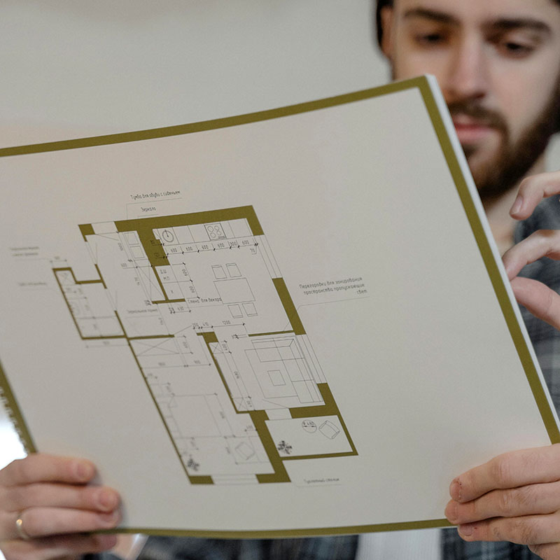 a person holding building plans