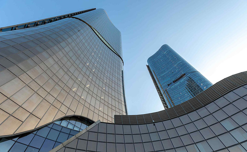 Looking up from the ground to the top of 2 skyscrapers