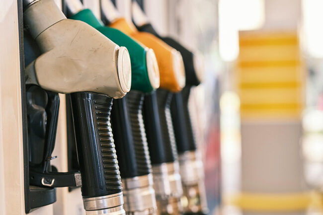 Petrol-pumps-pump-island-fuel - UFINANCIAL Gas station pump with multiple color-coded nozzles close-up