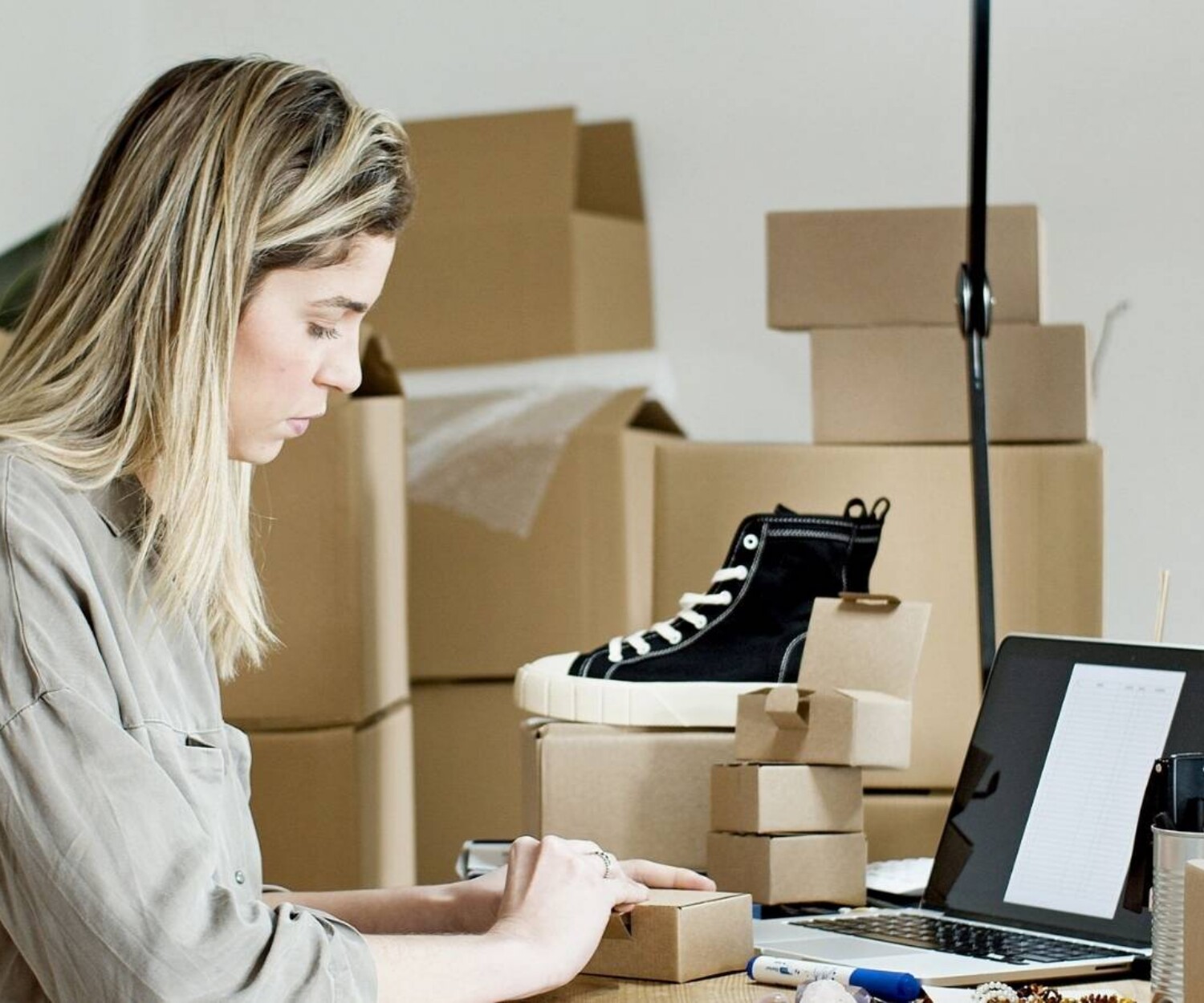 Woman packing shoes sold through her online business