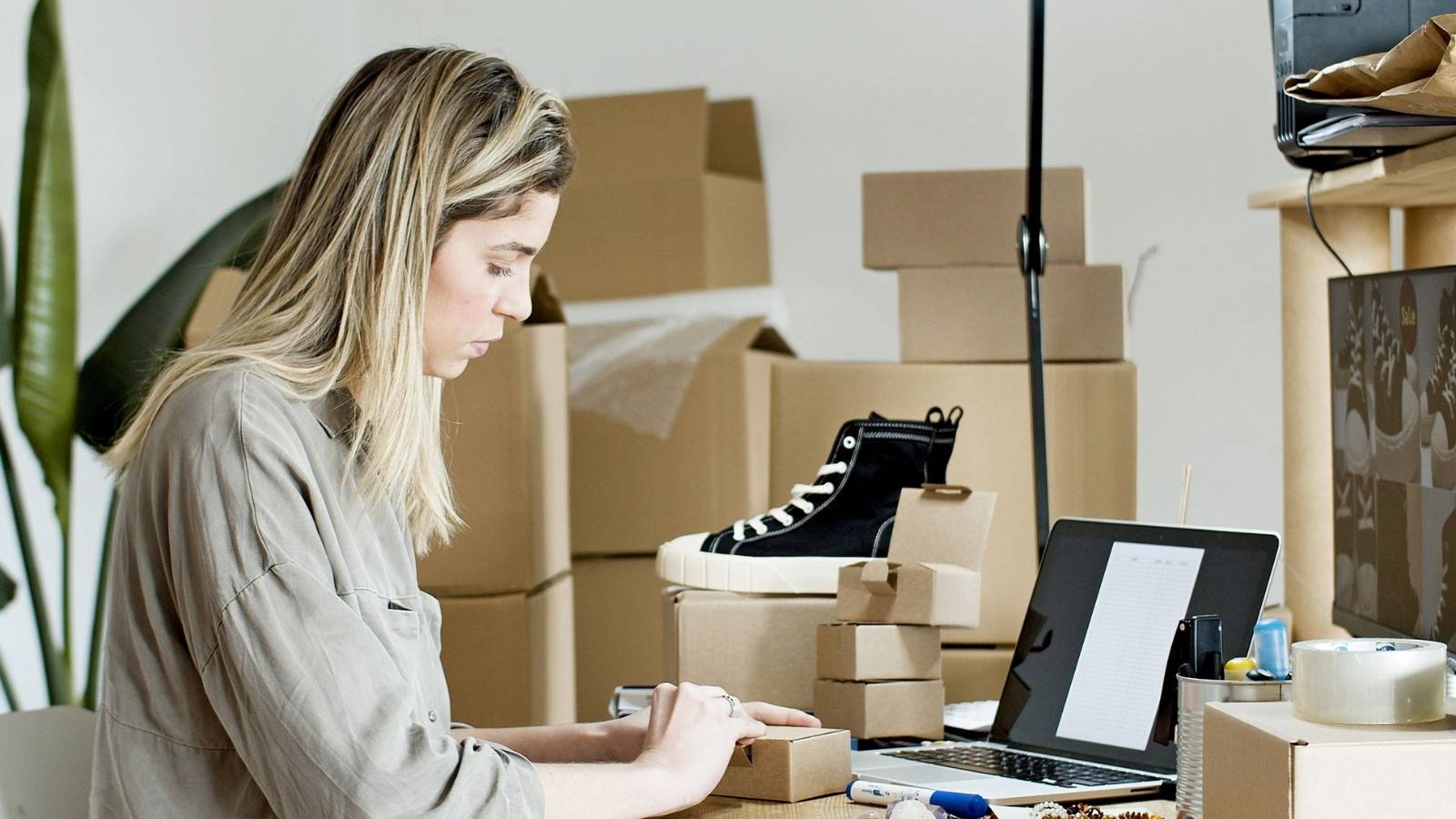 Woman packing shoes sold through her online business
